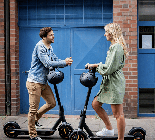 couple on scooters UK government legalise rental e-scooters on roads