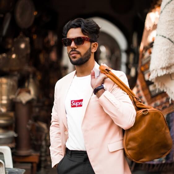 stylish man with leather duffel bag