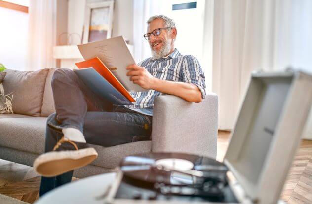 A man enjoying a vinyl experience with his old record player