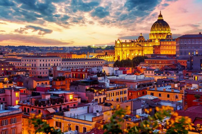 Cityscape view of Rome at sunset with St Peter Cathedral in Vatican