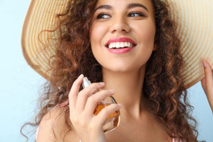 spraying perfume in summer