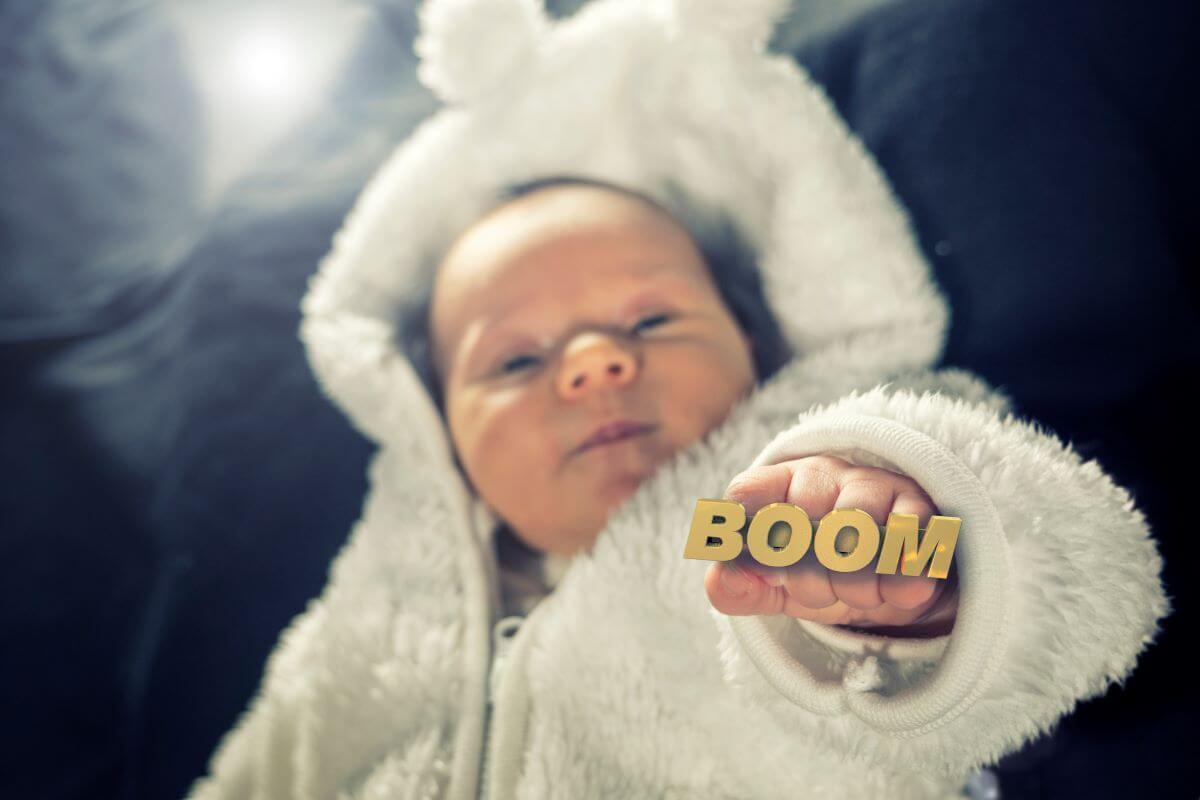baby holds up streetwear jewellery