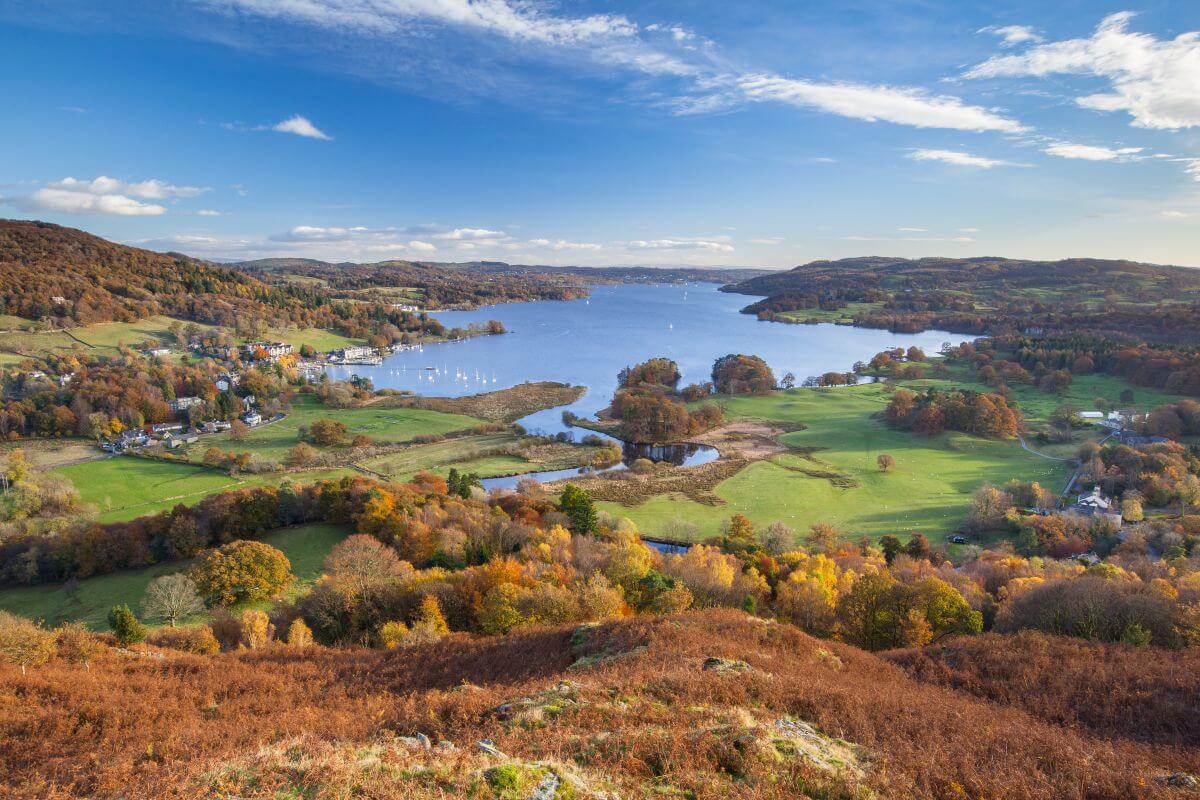 Windermere from Todd Crag on a sunny autumn day, golden trees and blue lake in England’s Lake District