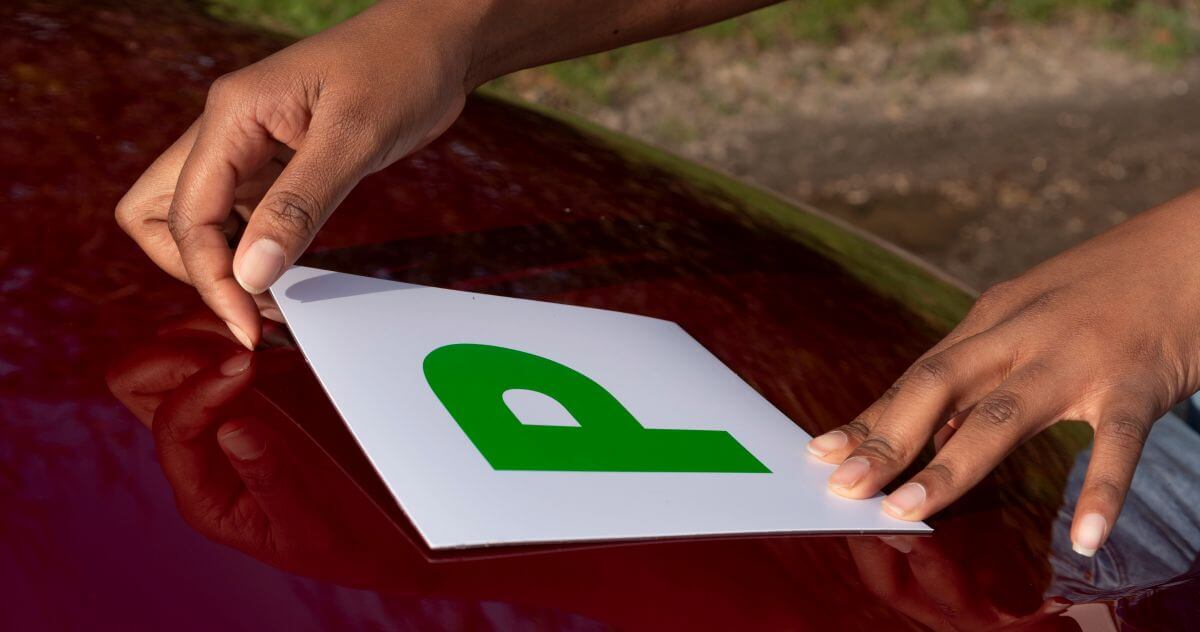 Smart Ways to Build Confidence Behind the Wheel as a New Driver 2 putting p plste on car in the uk