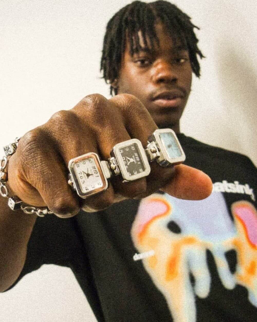 Domno streetwear rings and chain bracelet styled with graphic T-shirt