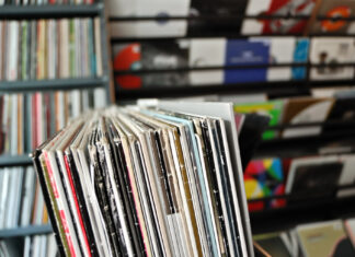 Buying second-hand vinyl: what VG+ means and what to check Vinyl records in worn sleeves arranged for browsing in a record shop