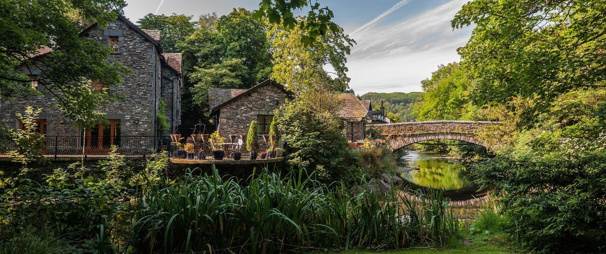 Stone buildings and a bridge over the river in Grasmere village