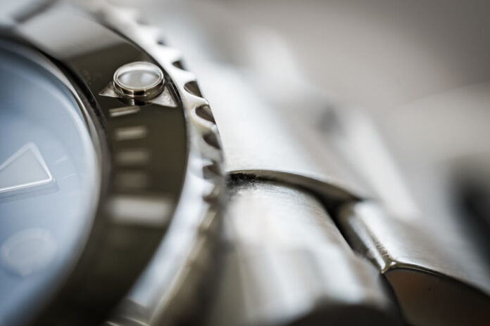 Close-up of a watch bezel and steel bracelet Close-up of a watch bezel, case and steel bracelet