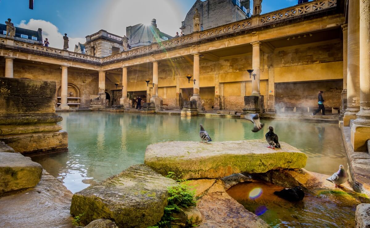 Steam rising from the Great Bath at the Roman Baths, surrounded by stone columns