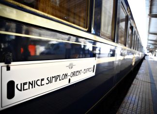 Venice Simplon-Orient-Express for Couples: Planning a Romantic Trip to Venice Blue and gold Venice Simplon-Orient-Express carriage with its name displayed beside the platform